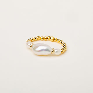Anello elasticizzato con perla centrale d'acqua dolce e sfere dorate