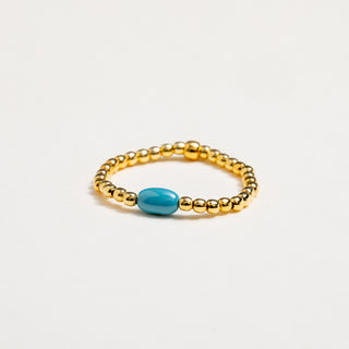 Anello elastico in argento placcato oro con pietra turchese naturale.