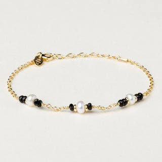 Bracciale in argento 925 dorato con perle e spinello dal design geometrico essenziale.