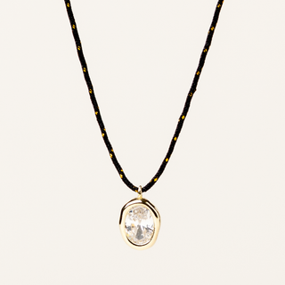 Collana a filo nero regolabile con pendente dorato e zircone Collezione Tacto.