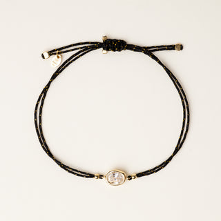 Bracciale a filo regolabile con elemento organico in argento dorato e zircone.