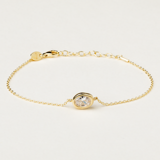 Bracciale a catena in argento dorato con centrale sagomato e zircone.