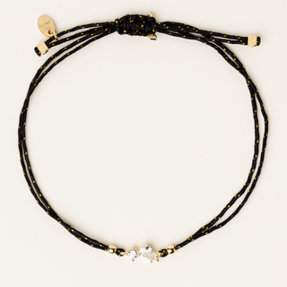 Bracciale a filo regolabile con goccia in argento dorato e zircone centrale.