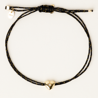 Bracciale a filo regolabile con charm a cuore in argento dorato e zircone.