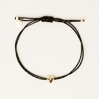 Bracciale a filo regolabile con charm a cuore in argento dorato e zircone.